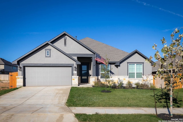 view of front of house featuring a front yard and a garage