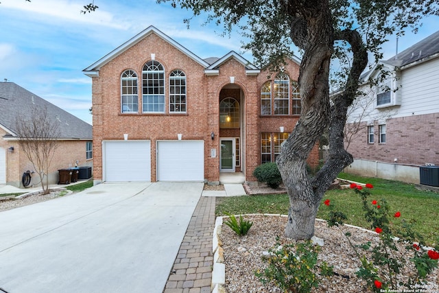 view of front property with a garage and central air condition unit