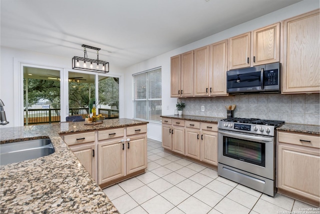 kitchen with tasteful backsplash, sink, appliances with stainless steel finishes, light brown cabinets, and light stone counters