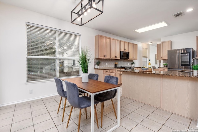 dining area with light tile patterned floors