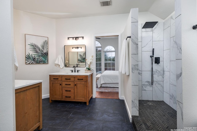 bathroom with vanity and tiled shower