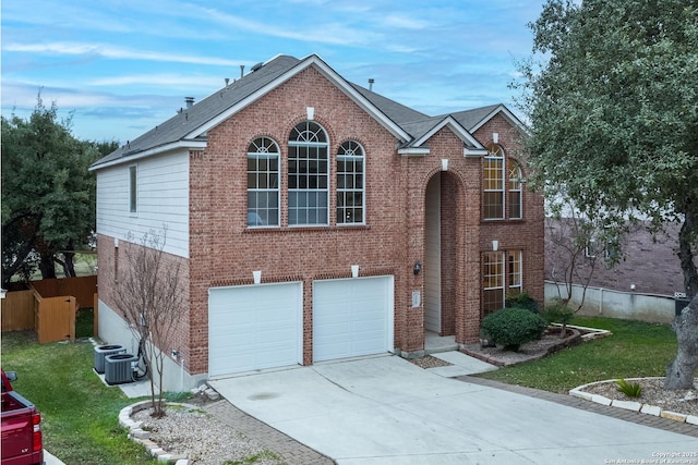 view of front property with a front lawn, a garage, and cooling unit