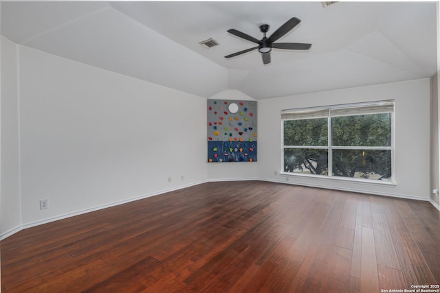 empty room with hardwood / wood-style flooring, ceiling fan, and vaulted ceiling