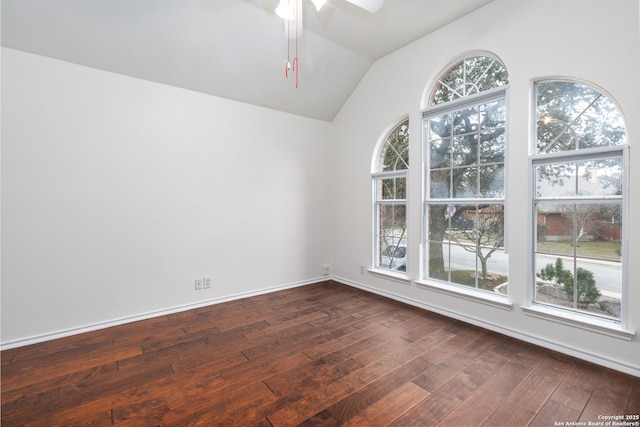 spare room with lofted ceiling, a healthy amount of sunlight, ceiling fan, and dark hardwood / wood-style floors