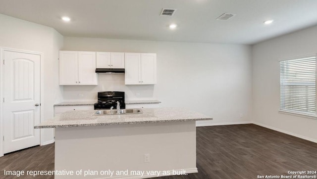 kitchen featuring dark wood-type flooring, white cabinetry, range, and a center island with sink