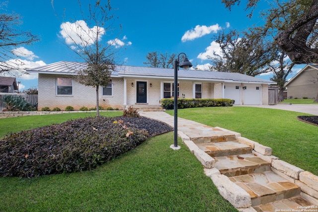 ranch-style house featuring a garage and a front yard