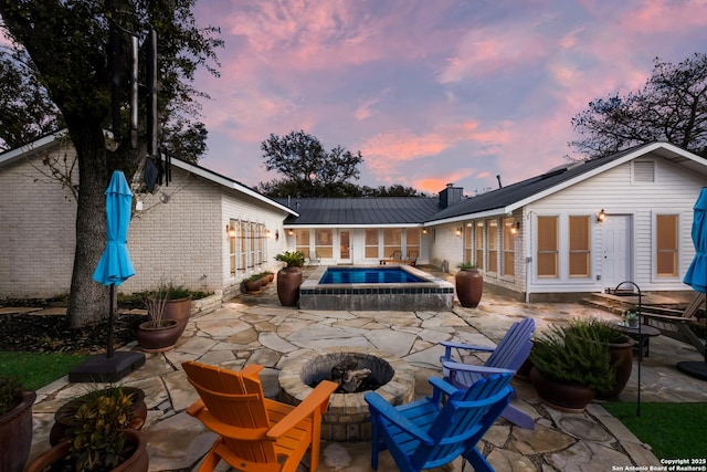 patio terrace at dusk with an outdoor fire pit