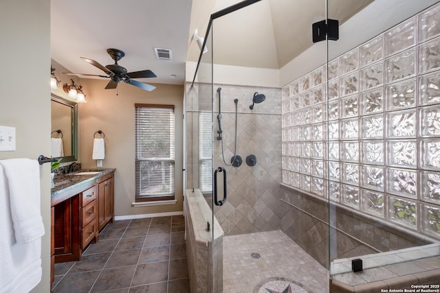 bathroom with ceiling fan, tile patterned floors, a shower with door, and vanity