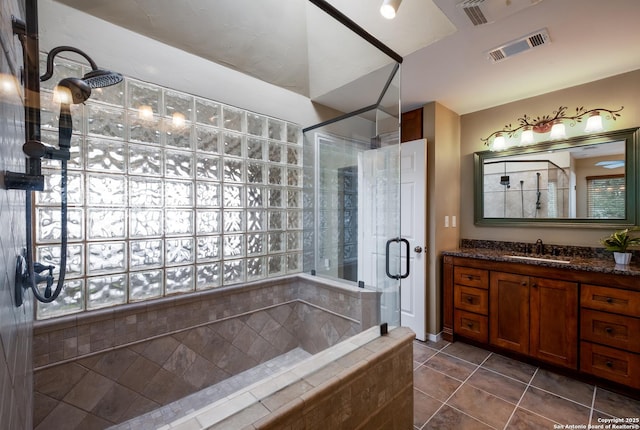 bathroom with vanity, tile patterned floors, and an enclosed shower