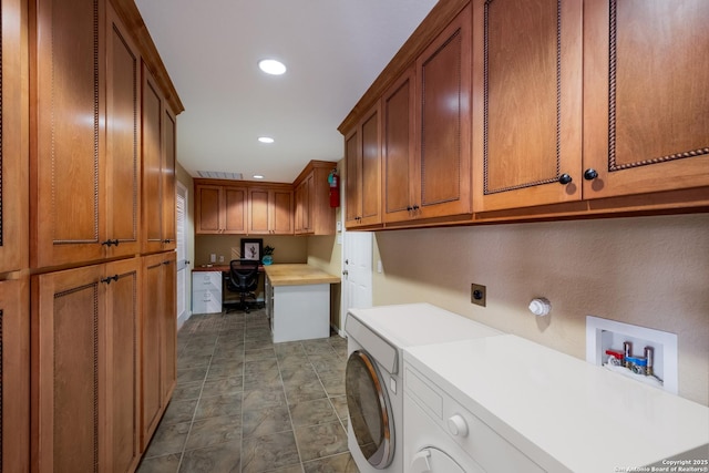 clothes washing area featuring washer / dryer and cabinets