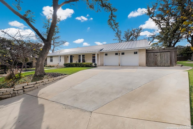 ranch-style house featuring a garage and a front lawn