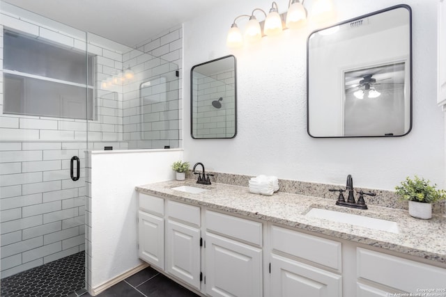 bathroom with vanity, tile patterned floors, and a shower with door