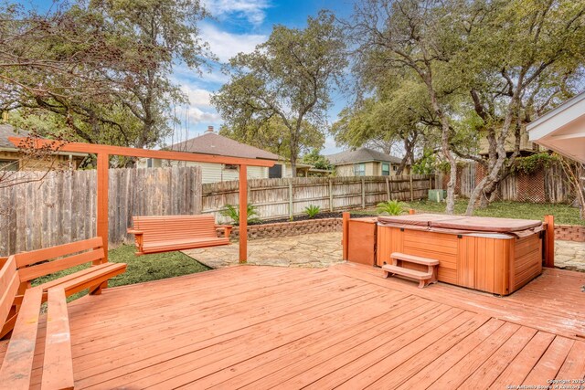 wooden terrace with a hot tub