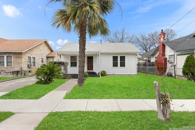 view of front of property featuring a front yard and cooling unit