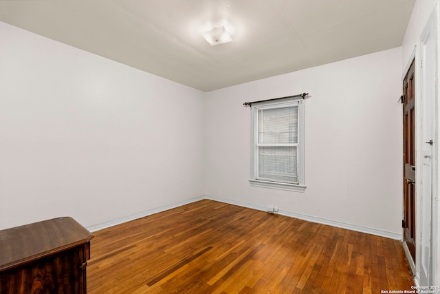 spare room with hardwood / wood-style floors