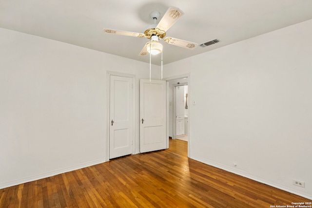 spare room with ceiling fan and wood-type flooring