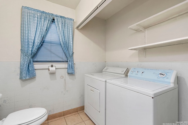 laundry area featuring light tile patterned floors and washer and clothes dryer