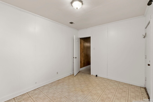 spare room featuring crown molding