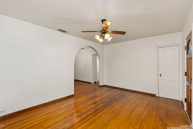 spare room with hardwood / wood-style flooring and ceiling fan