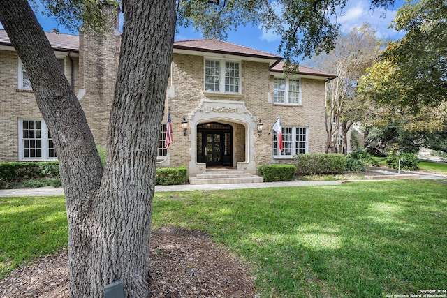 view of front of property featuring a front lawn and french doors