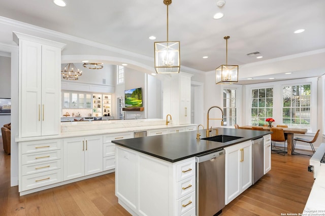 kitchen with decorative light fixtures, dishwasher, sink, white cabinetry, and light hardwood / wood-style flooring