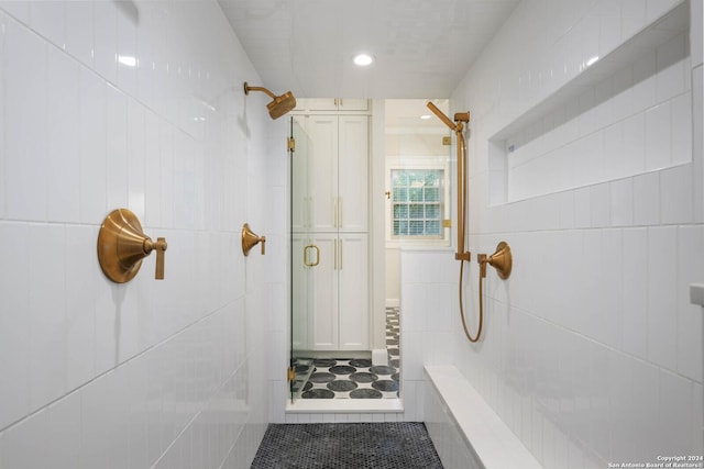 bathroom featuring tile patterned flooring and an enclosed shower