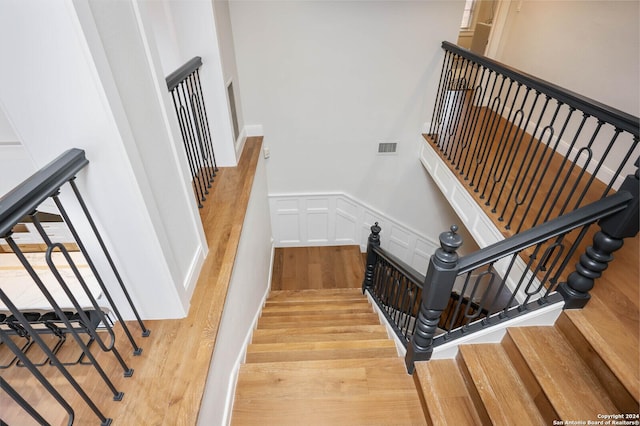 stairs with hardwood / wood-style floors