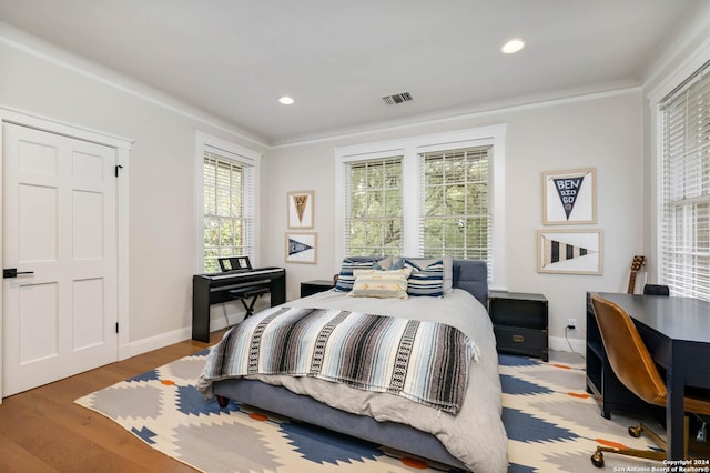 bedroom featuring crown molding and hardwood / wood-style flooring