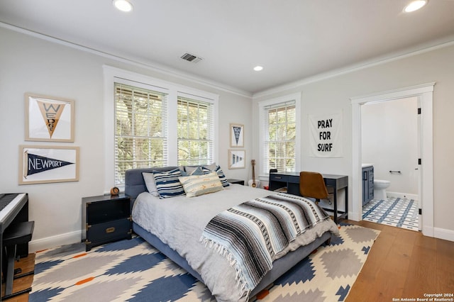 bedroom featuring crown molding, connected bathroom, and wood-type flooring