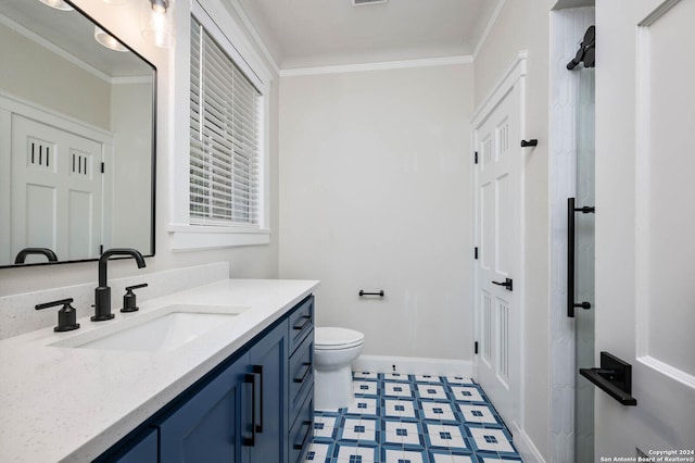 bathroom featuring toilet, crown molding, and vanity