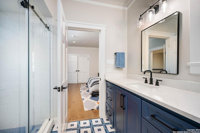 bathroom with vanity, wood-type flooring, a shower, and crown molding