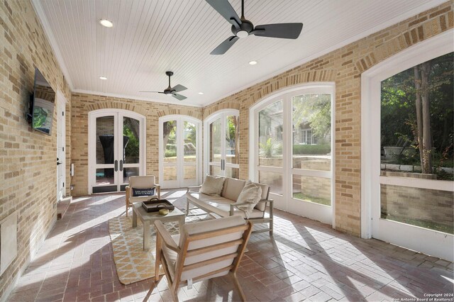 sunroom / solarium with ceiling fan and french doors