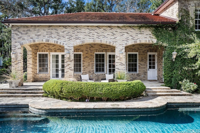 view of swimming pool featuring french doors