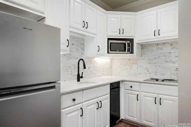 kitchen with white cabinets, appliances with stainless steel finishes, and sink