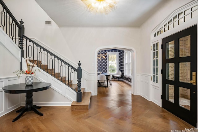 entryway with parquet flooring and french doors