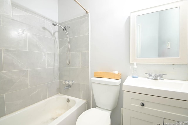 full bathroom with toilet, tiled shower / bath combo, and vanity