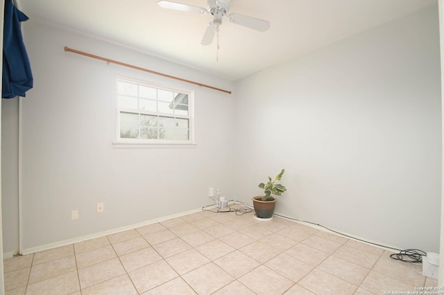 tiled spare room featuring ceiling fan