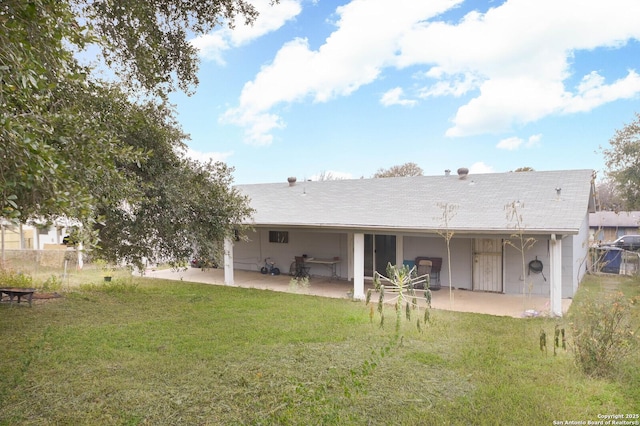 back of property with a patio area and a yard