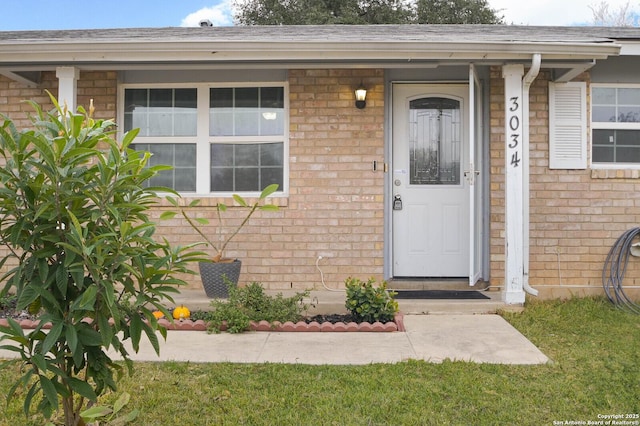 property entrance with a yard