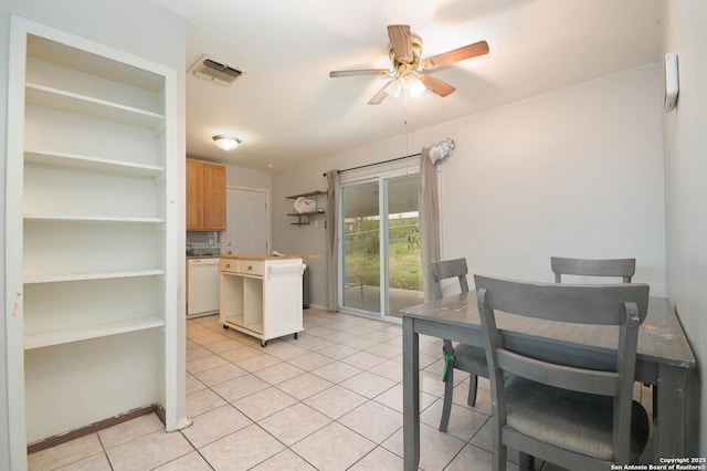 kitchen with light brown cabinets, white dishwasher, backsplash, ceiling fan, and light tile patterned floors