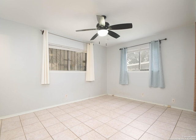 tiled spare room featuring ceiling fan