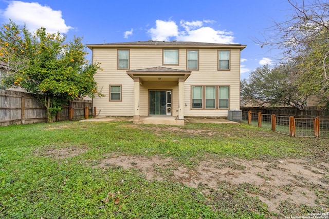 back of house with a yard, central AC unit, and a patio