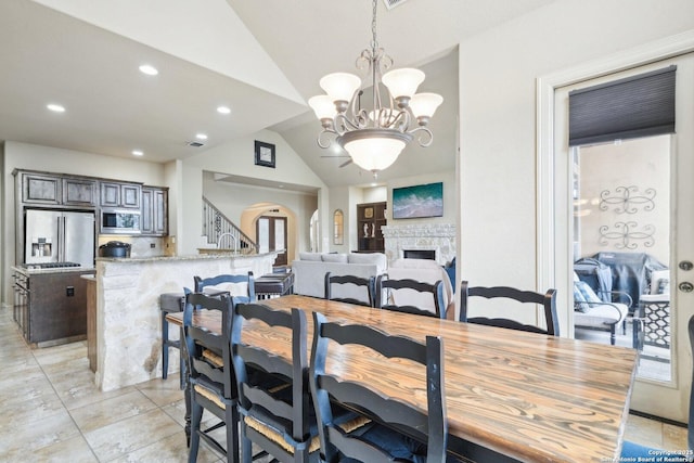 dining area featuring vaulted ceiling and a notable chandelier