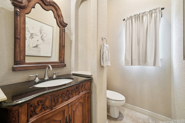 bathroom featuring toilet and vanity