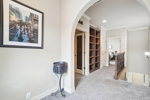 hallway featuring light colored carpet and ornamental molding