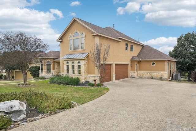 view of front facade featuring a garage, a front yard, and central air condition unit