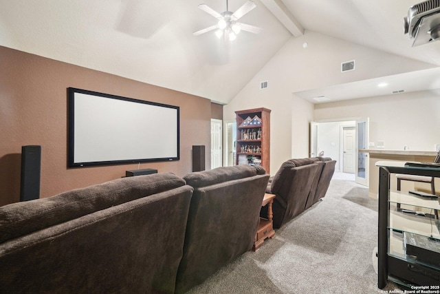 cinema room featuring ceiling fan, light colored carpet, beamed ceiling, and high vaulted ceiling