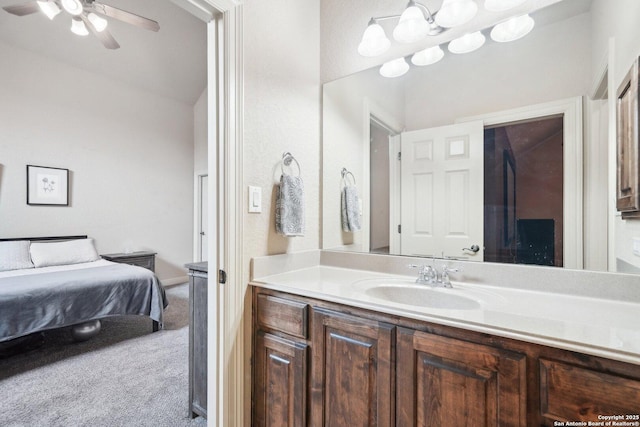 bathroom featuring vaulted ceiling, ceiling fan, and vanity