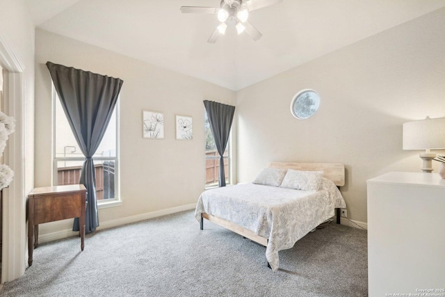 carpeted bedroom featuring ceiling fan, vaulted ceiling, and multiple windows