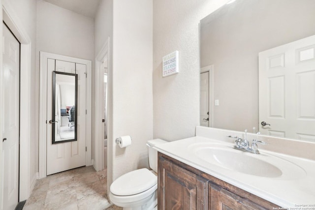 bathroom featuring toilet and vanity